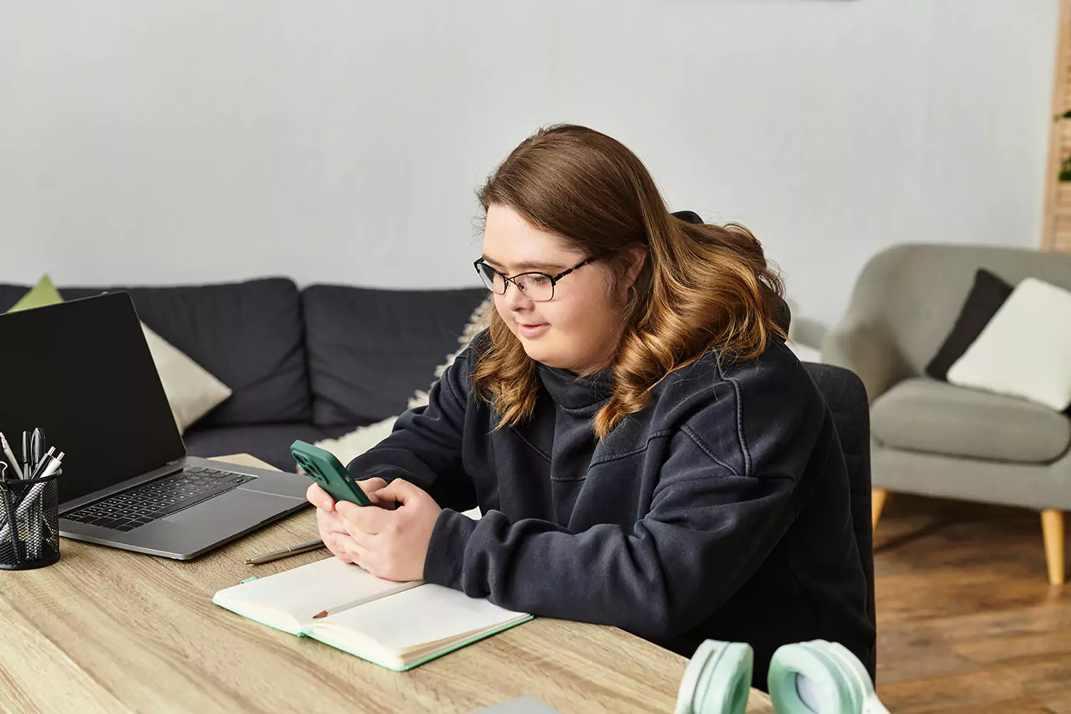 A young woman with down syndrome is using her phone to contact Golden Haven
